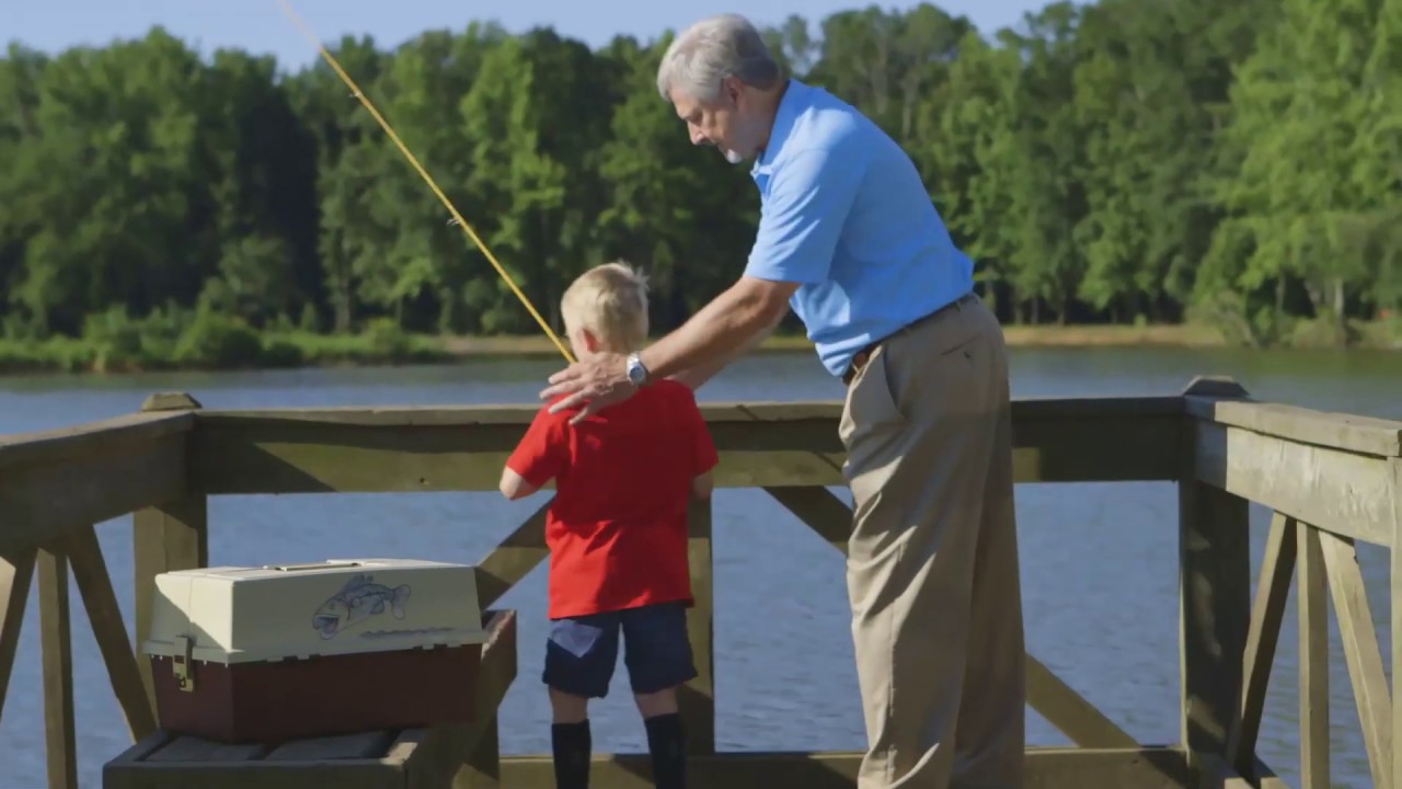 Man is fishing with a small boy